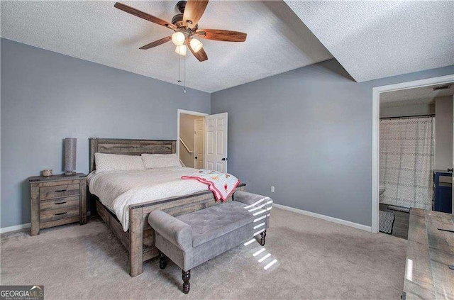 carpeted bedroom featuring ceiling fan and a textured ceiling