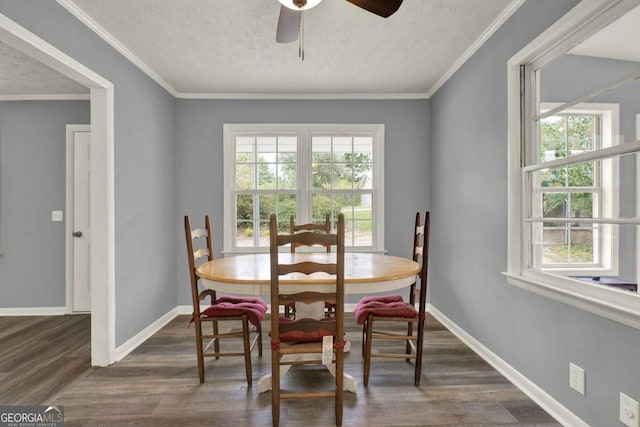 dining area with a textured ceiling, dark hardwood / wood-style floors, ceiling fan, and crown molding