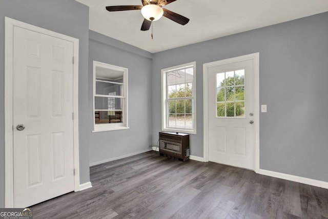 foyer featuring heating unit, ceiling fan, and dark wood-type flooring