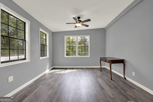 spare room featuring lofted ceiling, ceiling fan, and dark wood-type flooring