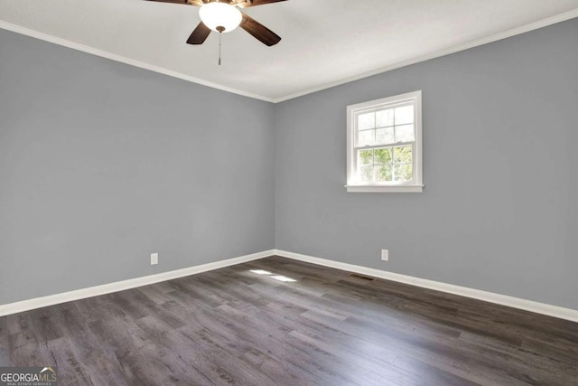 empty room featuring dark hardwood / wood-style flooring, ceiling fan, and ornamental molding