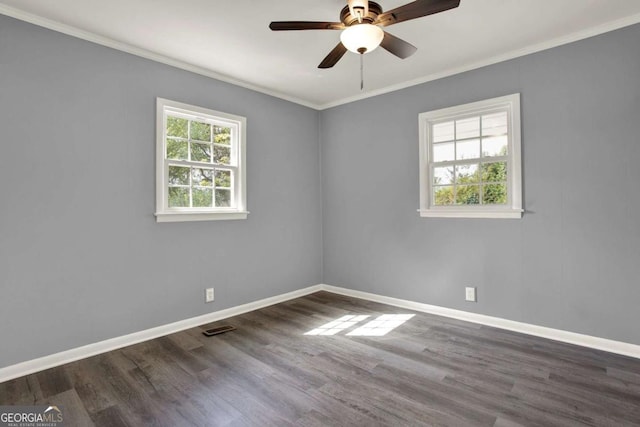 spare room featuring crown molding, ceiling fan, and dark wood-type flooring