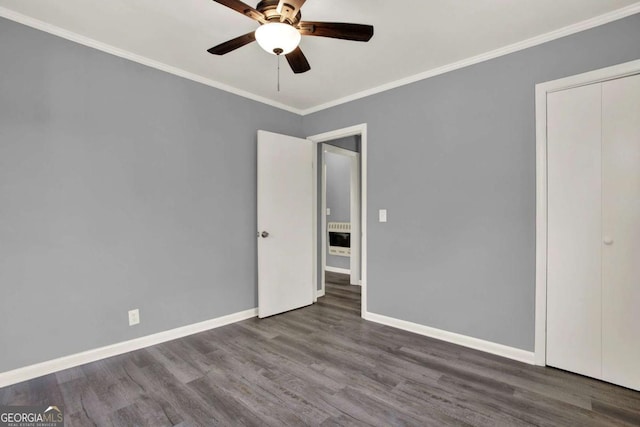 unfurnished bedroom with a closet, ceiling fan, crown molding, and wood-type flooring