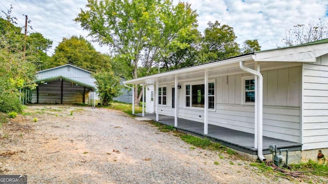 view of side of home with covered porch