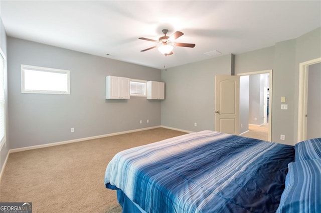 bedroom featuring light colored carpet and ceiling fan