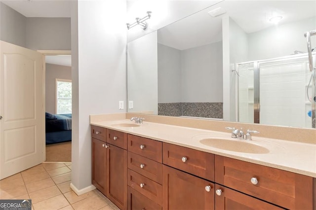 bathroom with tile patterned flooring, vanity, and walk in shower