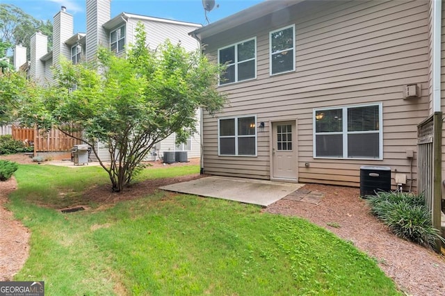 back of property with a patio area and a yard