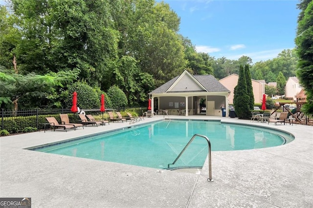 view of pool with a patio area and an outdoor structure