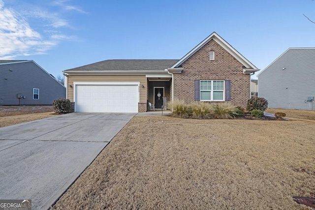 view of front of property featuring a front yard and a garage