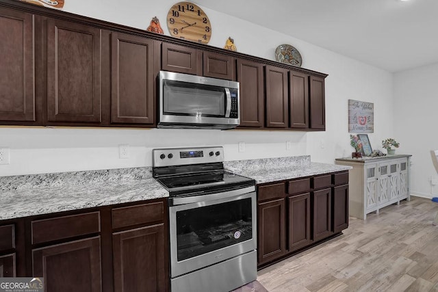 kitchen featuring light hardwood / wood-style floors, stainless steel appliances, light stone countertops, and dark brown cabinetry