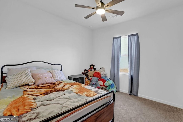 bedroom featuring light colored carpet and ceiling fan