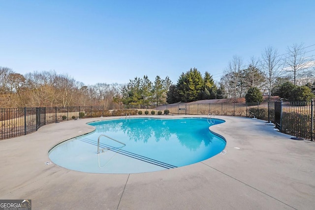 view of swimming pool with a patio area