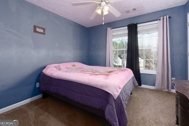 carpeted bedroom with ceiling fan and a textured ceiling