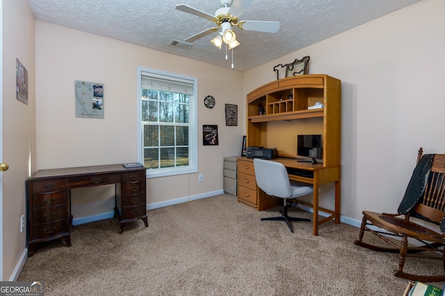 office area featuring a textured ceiling, light colored carpet, and ceiling fan