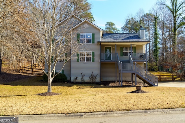 view of front of home featuring covered porch and a front yard