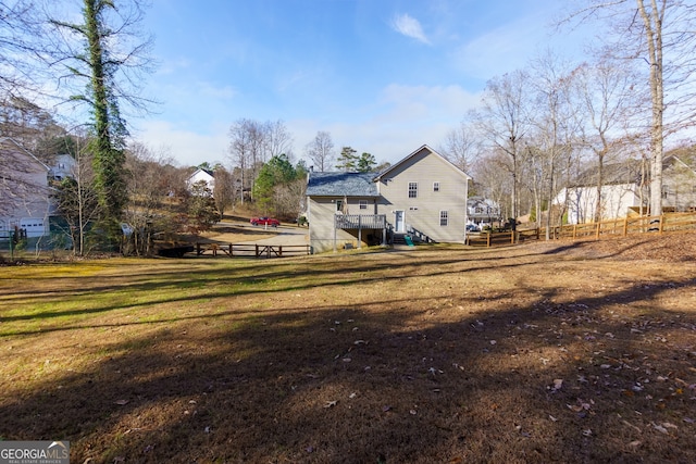 rear view of house with a yard and a deck