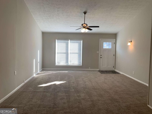 unfurnished living room featuring ceiling fan, carpet floors, and a textured ceiling