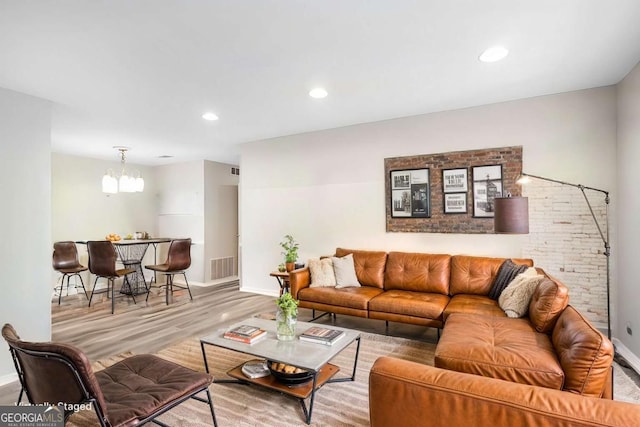 living room featuring hardwood / wood-style floors and an inviting chandelier