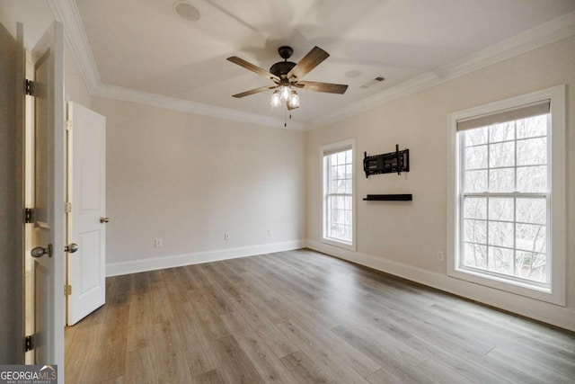 unfurnished room featuring ceiling fan, crown molding, and light hardwood / wood-style flooring