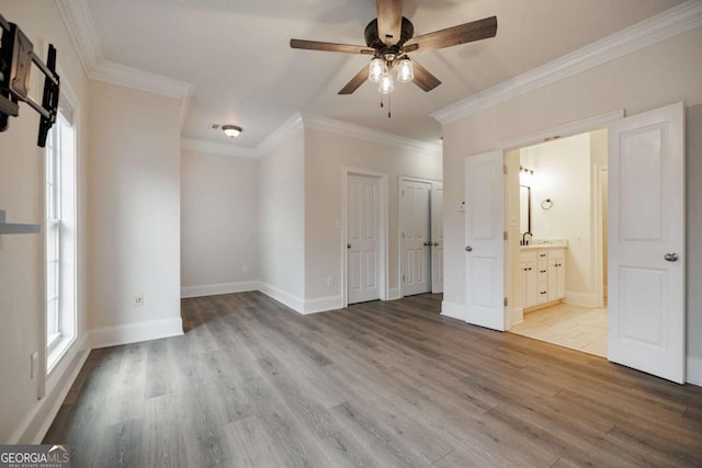 unfurnished bedroom with ceiling fan, ornamental molding, connected bathroom, and light hardwood / wood-style flooring