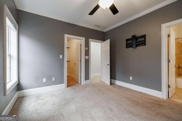 unfurnished bedroom with ensuite bathroom, crown molding, ceiling fan, and light carpet