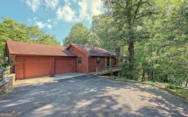 view of front of property featuring a garage and a deck