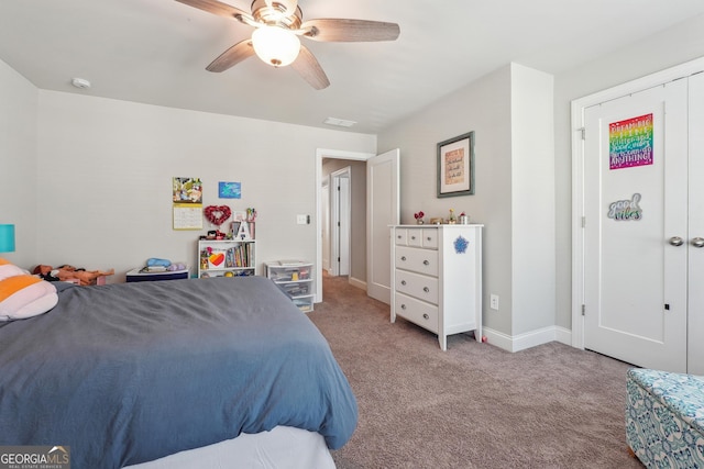 bedroom featuring ceiling fan, light carpet, and a closet