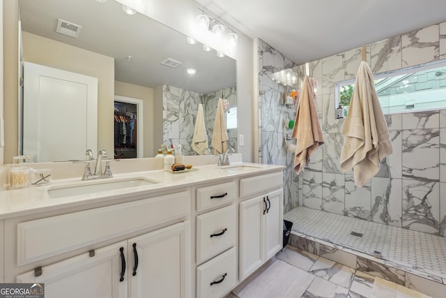 bathroom featuring vanity and tiled shower