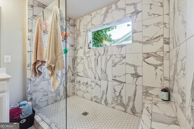 bathroom with vanity and tiled shower