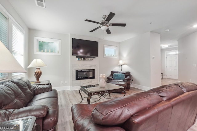 living room with ceiling fan and light hardwood / wood-style floors