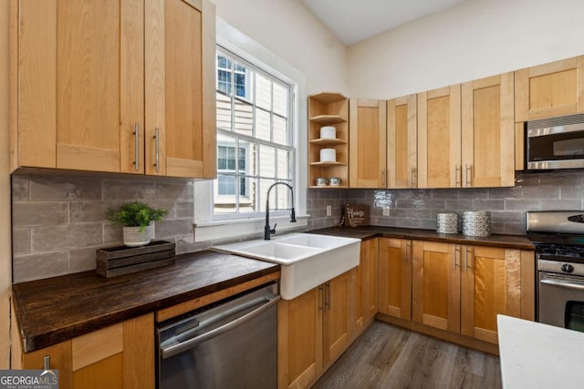 kitchen with appliances with stainless steel finishes, backsplash, and sink