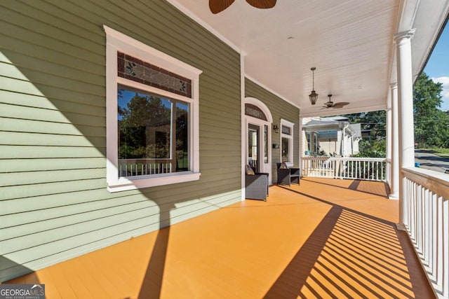 wooden deck featuring a porch and ceiling fan