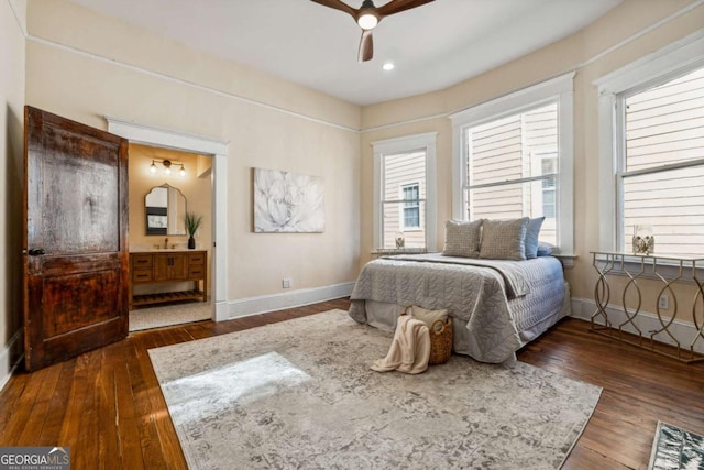 bedroom with connected bathroom, ceiling fan, and dark hardwood / wood-style floors