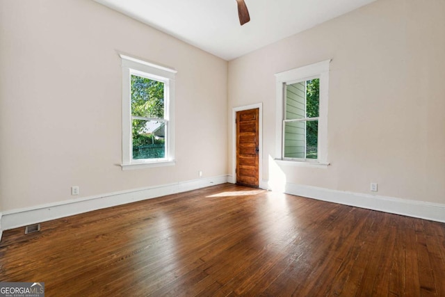 empty room with hardwood / wood-style floors and ceiling fan