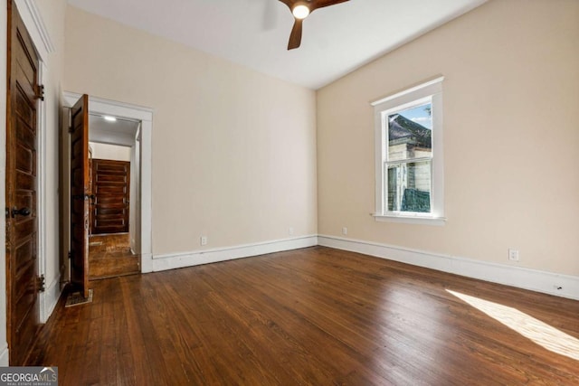 empty room with ceiling fan and dark hardwood / wood-style flooring