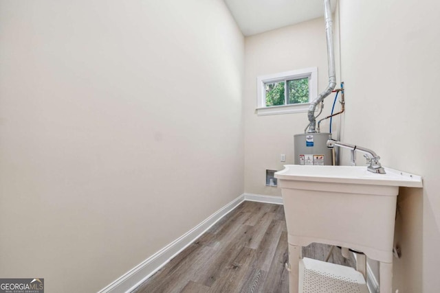 bathroom with gas water heater and hardwood / wood-style flooring