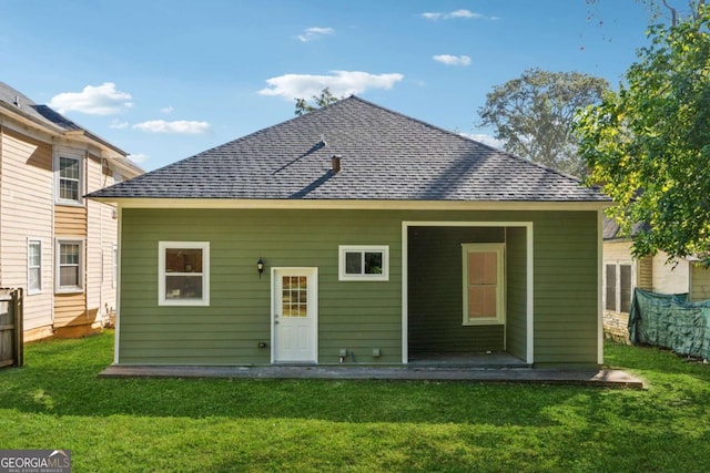 rear view of house with a yard