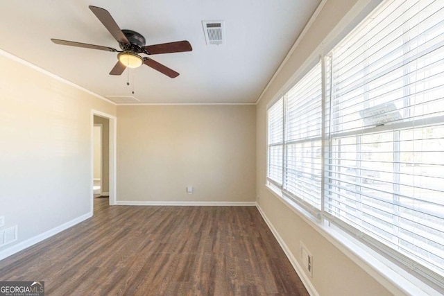 empty room featuring dark hardwood / wood-style flooring, ceiling fan, and crown molding