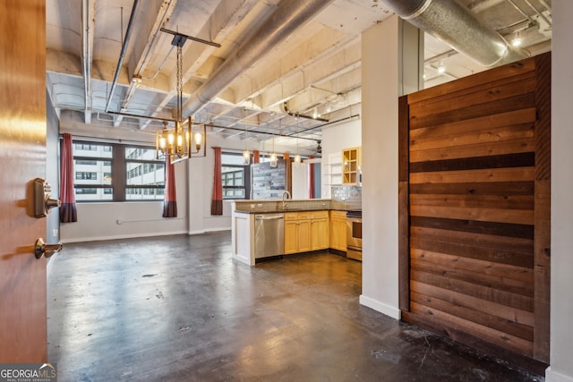 kitchen with backsplash, kitchen peninsula, stainless steel dishwasher, decorative light fixtures, and range