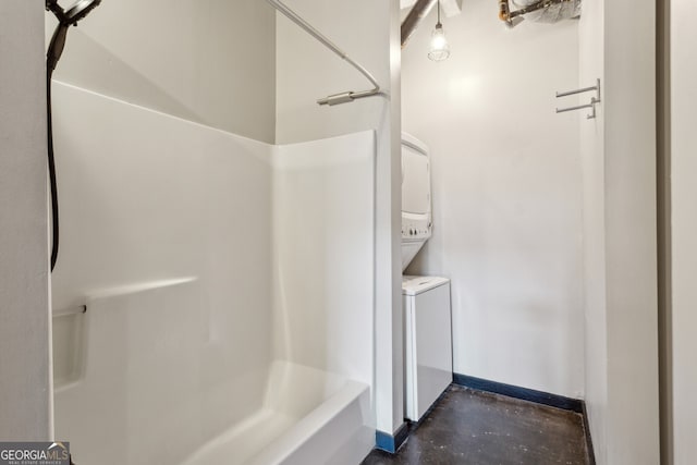 bathroom with shower / washtub combination and concrete floors