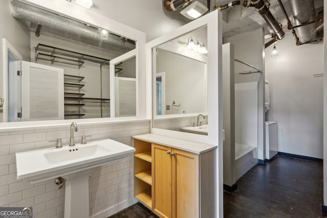 bathroom with tasteful backsplash and tile walls