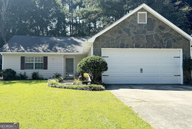 ranch-style home with a front yard and a garage