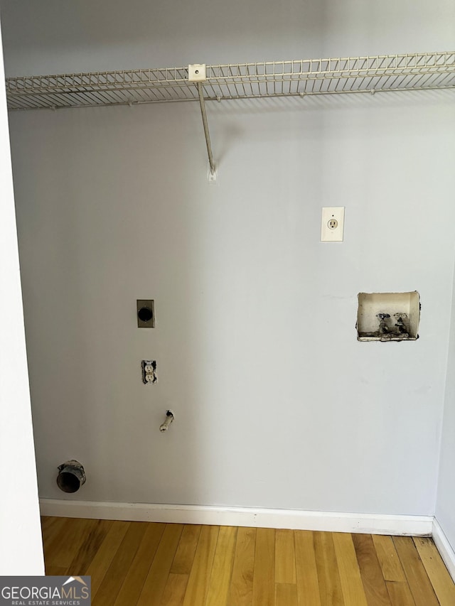 clothes washing area featuring hookup for an electric dryer, hookup for a washing machine, and wood-type flooring