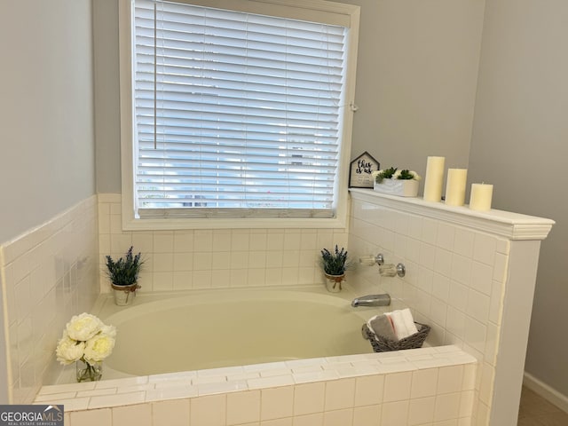 bathroom with a wealth of natural light and tiled bath