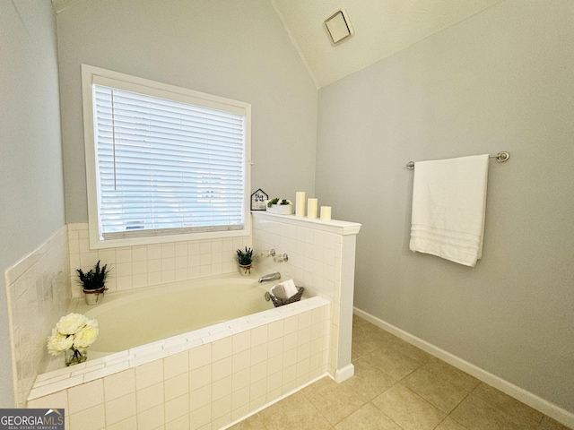 bathroom with a tub, tile patterned flooring, and vaulted ceiling