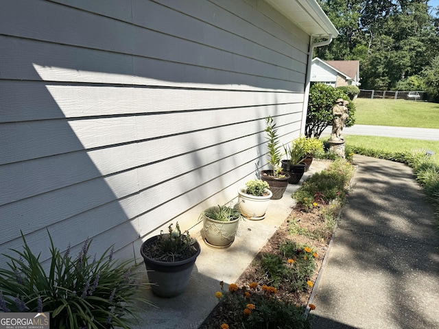 view of side of home with a lawn