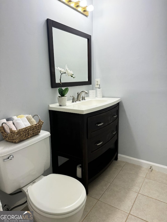 bathroom with tile patterned flooring, vanity, and toilet