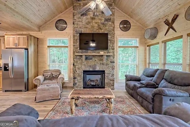 living room with ceiling fan, wood ceiling, wooden walls, and light hardwood / wood-style floors