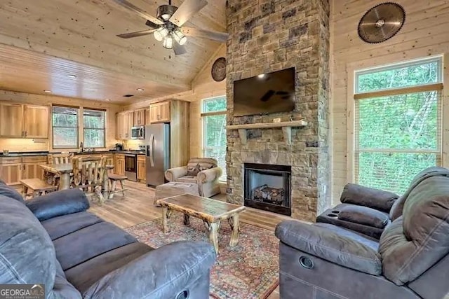 living room featuring ceiling fan, hardwood / wood-style floors, a wealth of natural light, and wooden ceiling