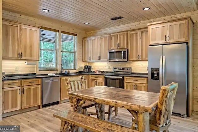 kitchen featuring appliances with stainless steel finishes, light brown cabinets, light hardwood / wood-style floors, sink, and wooden ceiling